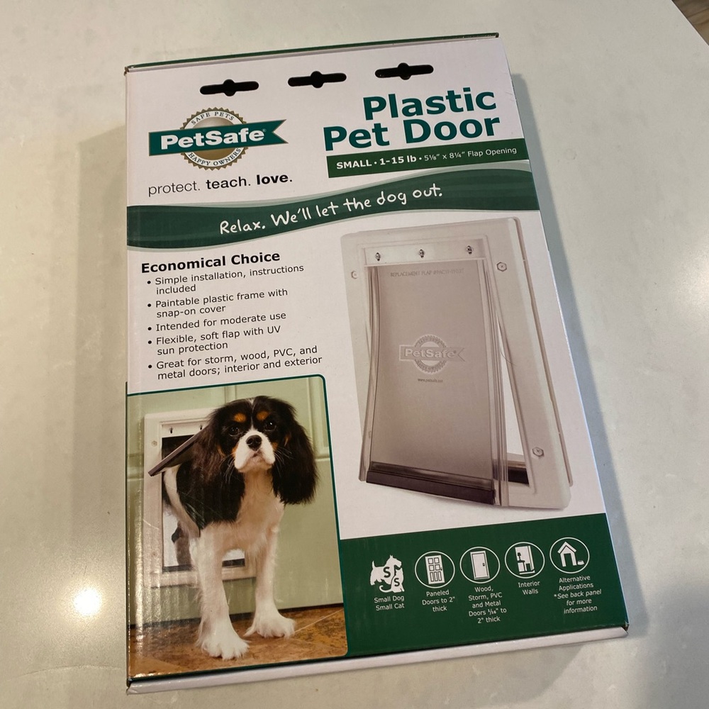 Pet safe small doggie door never used!!! Brand new box is sealed